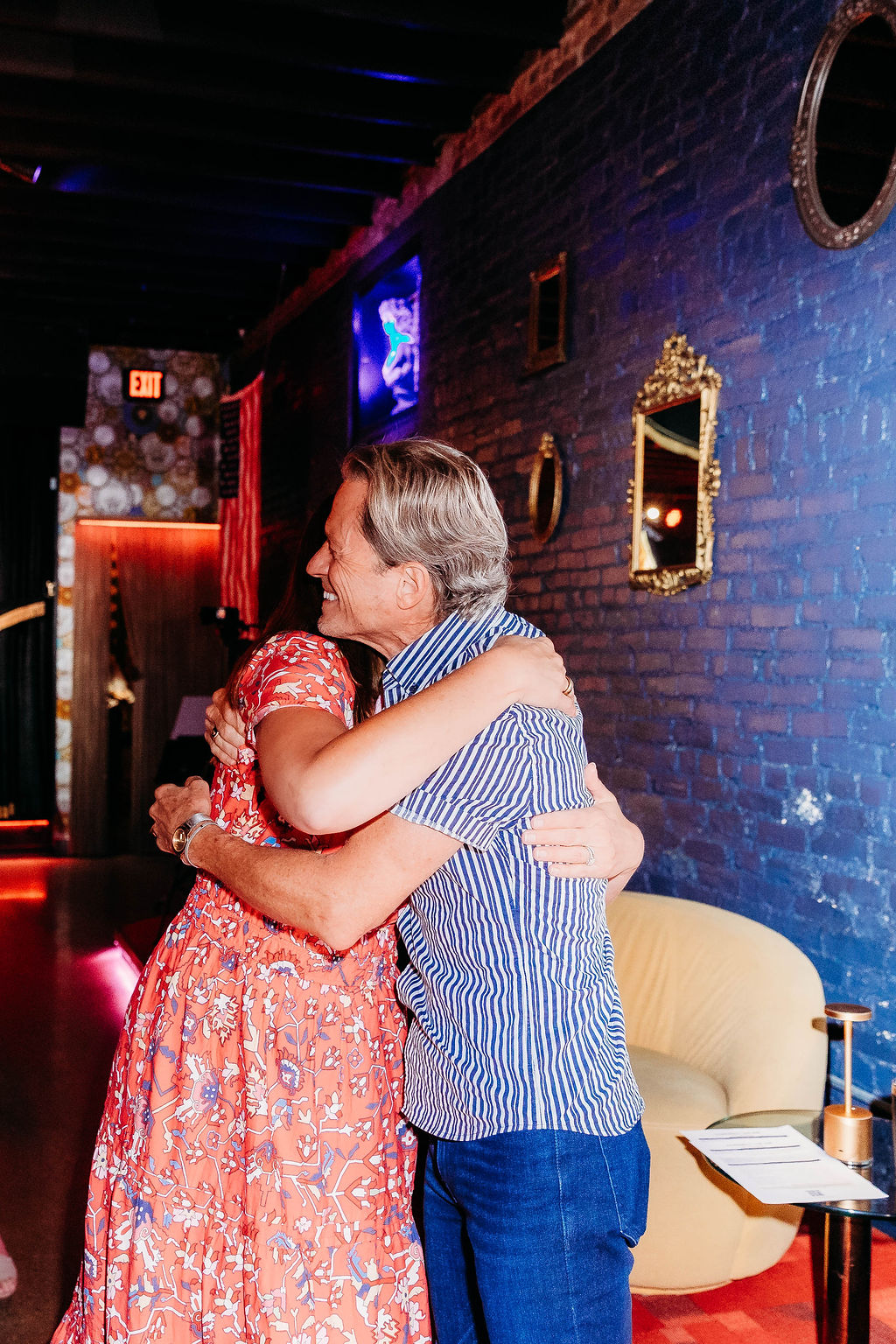 Two attendees sharing a hug at a Connect or Die event