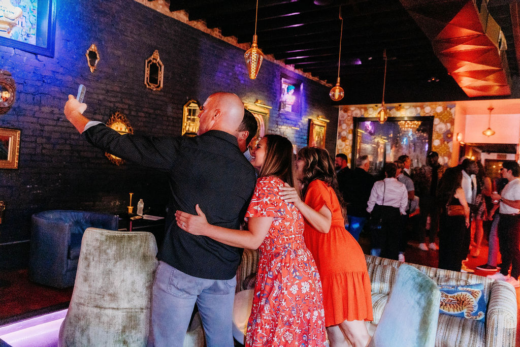 Guests taking a selfie together at a previous Connect or Die activation