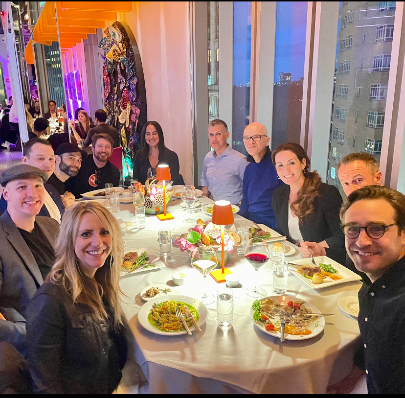 Guests gathered around a dinner table at a Connect or Die private dinner